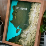 Laser engraved topical map of Ecuador in a brown frame