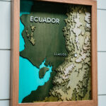 Laser engraved topical map of Ecuador in a brown frame