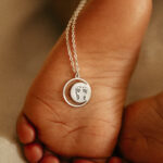 Silver laser engraved footprint pendant