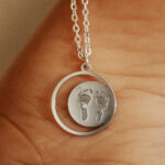 Silver laser engraved footprint pendant