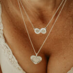 Silver heart shaped and infinity shaped breastmilk filled pendants