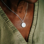 Silver breastmilk filled circle pendant