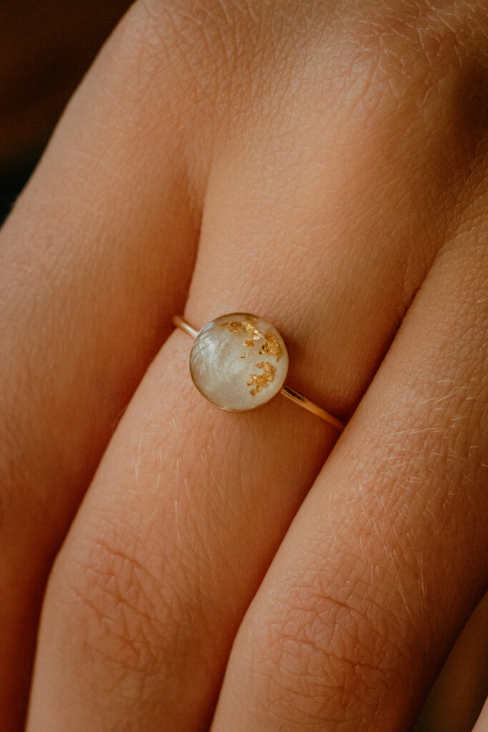 Gold breastmilk filled ring with gold flakes