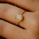 Gold breastmilk filled ring with gold flakes