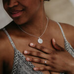 Woman wearing silver laser engraved breastmilk necklace