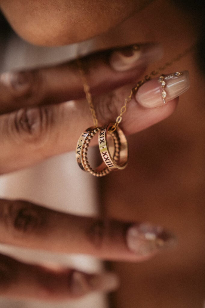 Close-up of gold and rose gold rings with Roman numerals and diamond accents.